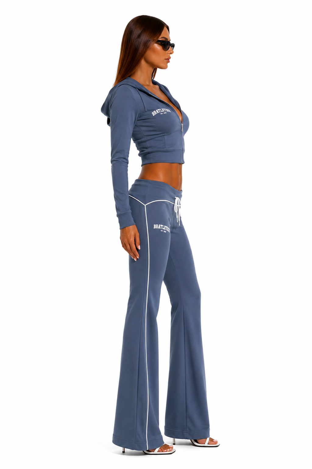 Woman wearing a blue tracksuit with 'BRATLETICS' branding on a white background
