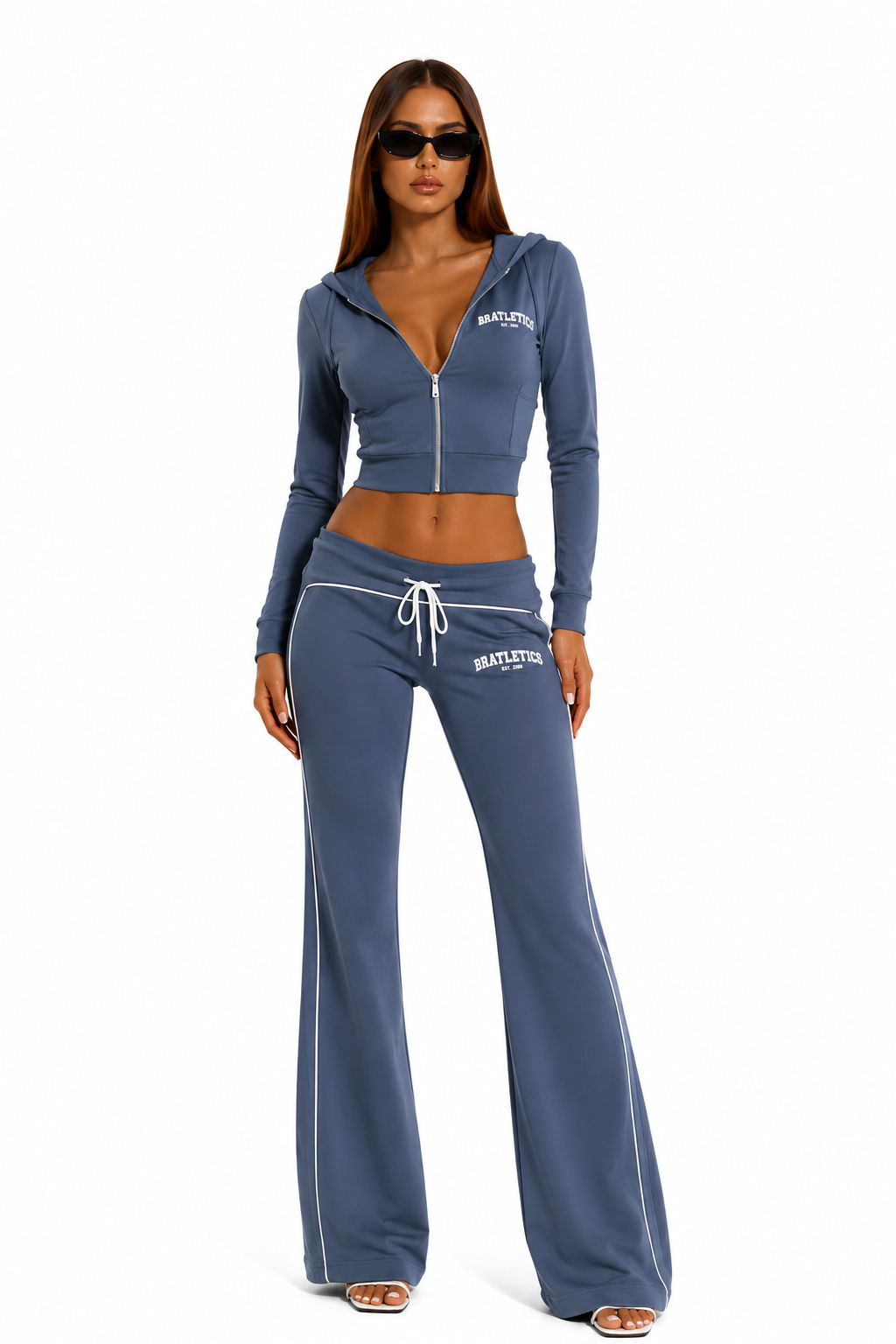 Woman wearing a blue tracksuit with a visible brand logo on a white background