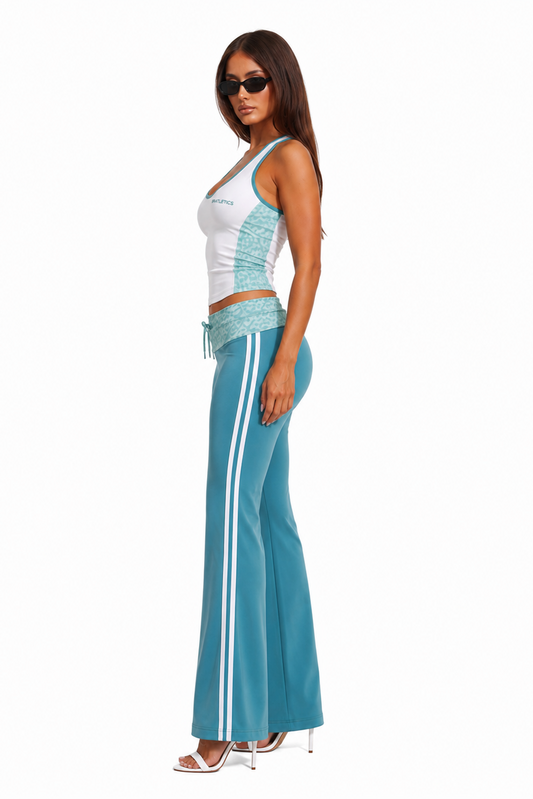 Woman wearing a white and blue top with matching flared pants on a white background