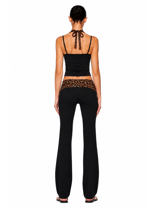 Back view of the BRATLETICS leopard print activewear set, showcasing the sports bra back design and high-waisted leggings with a flattering, sculpting fit in brown and black leopard print.