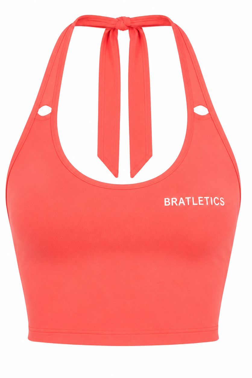 A coral red halter crop top with a front tie detail and the word 'BRATLETICS' printed in white on the left chest, shown against a plain white background.
